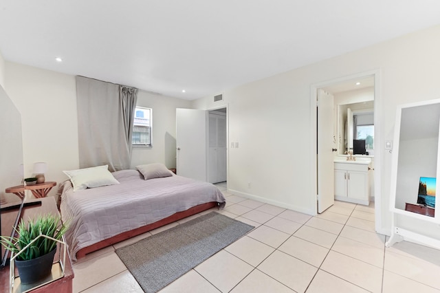 271 Saxony Unit F, Delray Beach, FL 33446 - bedroom featuring light tile patterned flooring, recessed lighting, a sink, baseboards, and ensuite bath
