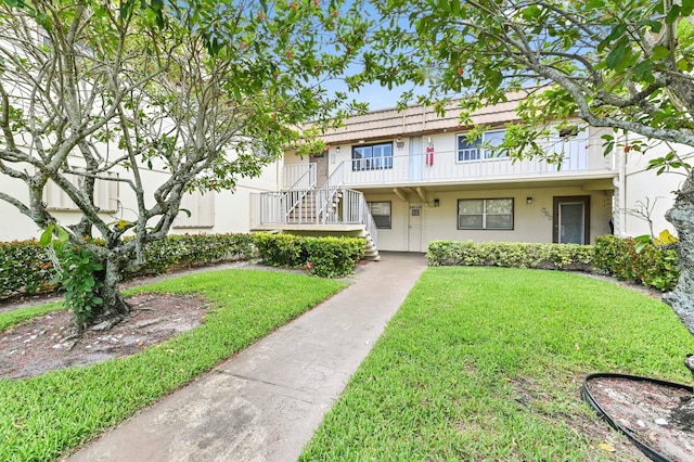 271 Saxony Unit F, Delray Beach, FL 33446 - townhome / multi-family property with a front yard, stucco siding, and stairway