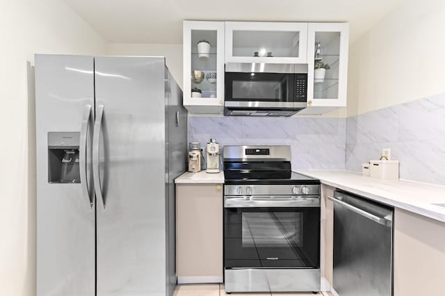 271 Saxony Unit F, Delray Beach, FL 33446 - kitchen with stainless steel appliances, light countertops, white cabinetry, and tasteful backsplash