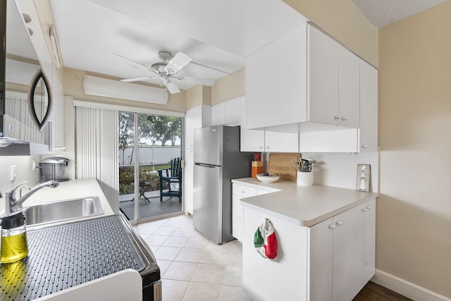 1470 S Ocean Blvd Unit 1101, Pompano Beach, FL 33062 - kitchen with a sink, freestanding refrigerator, ceiling fan, and white cabinetry