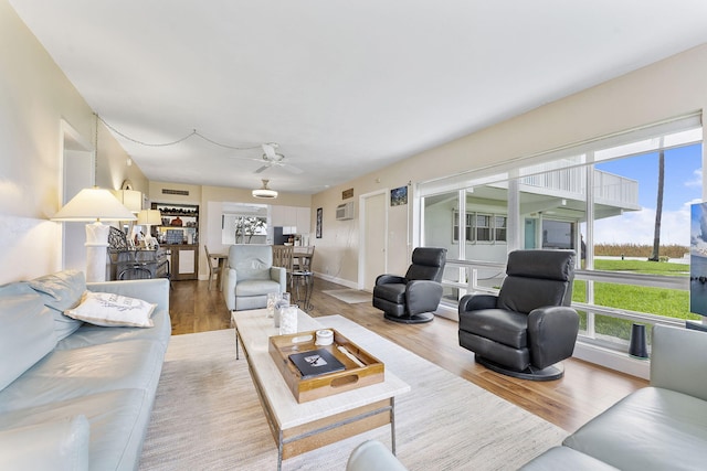 1470 S Ocean Blvd Unit 1101, Pompano Beach, FL 33062 - living area with light wood finished floors, ceiling fan, and a wall mounted AC