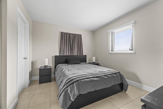 1528 Singletary Ave, Pahokee, FL 33476 - bedroom with light tile patterned floors and baseboards