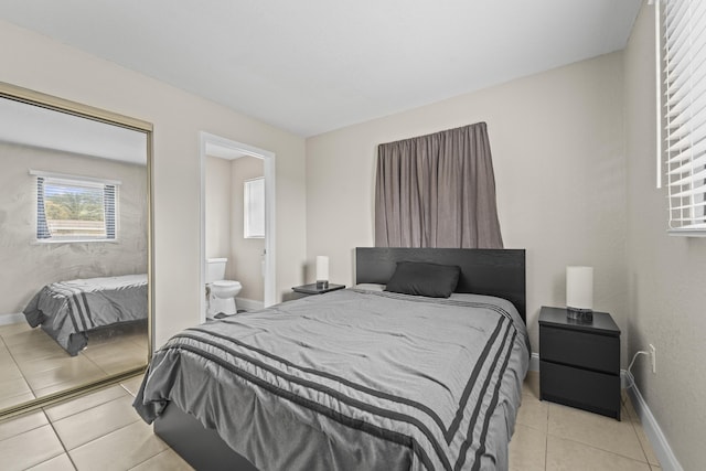1528 Singletary Ave, Pahokee, FL 33476 - bedroom with light tile patterned flooring, baseboards, ensuite bathroom, and a closet