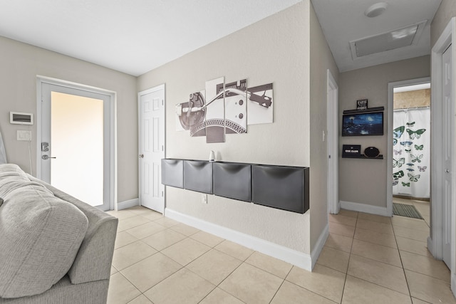 1528 Singletary Ave, Pahokee, FL 33476 - corridor featuring attic access, light tile patterned floors, and baseboards
