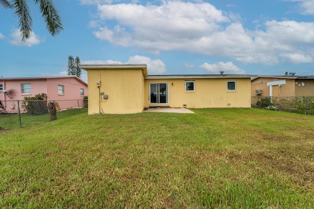 1528 Singletary Ave, Pahokee, FL 33476 - back of house with stucco siding and a wall unit AC