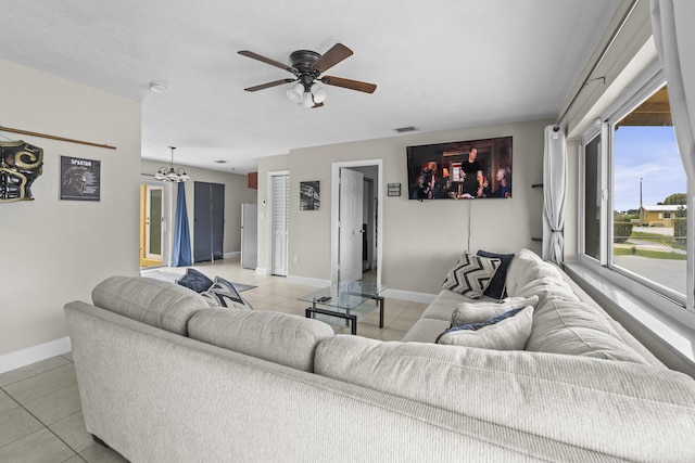 1528 Singletary Ave, Pahokee, FL 33476 - living area featuring light tile patterned floors, baseboards, a ceiling fan, and a chandelier