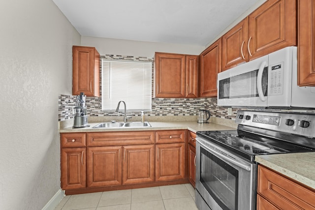 1528 Singletary Ave, Pahokee, FL 33476 - kitchen featuring stainless steel electric range, a sink, white microwave, backsplash, and light countertops