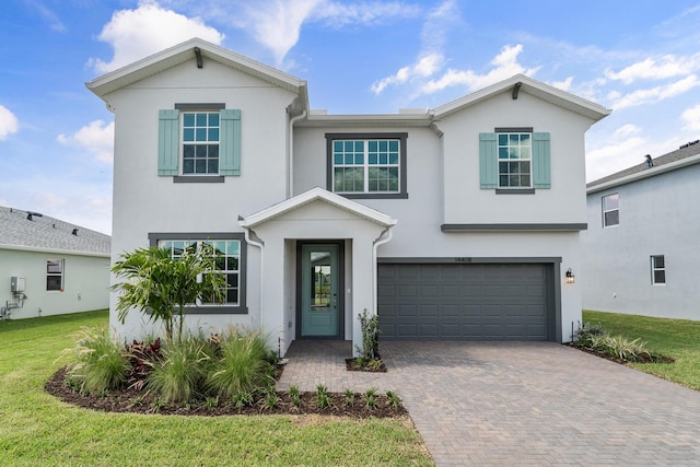 14408 SW Ellison Dr, Port Saint Lucie, FL 34987 - view of front facade with stucco siding, an attached garage, decorative driveway, and a front lawn
