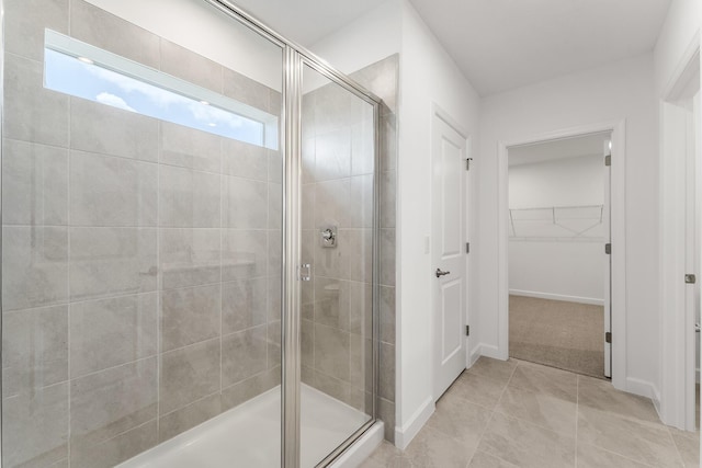 14408 SW Ellison Dr, Port Saint Lucie, FL 34987 - full bath featuring a stall shower, a spacious closet, tile patterned flooring, and baseboards