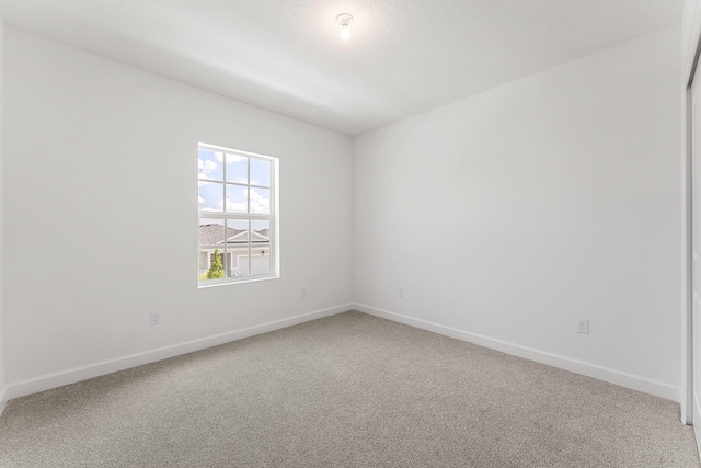 14408 SW Ellison Dr, Port Saint Lucie, FL 34987 - spare room featuring carpet and baseboards