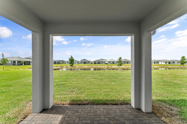 14408 SW Ellison Dr, Port Saint Lucie, FL 34987 - view of grassy yard featuring a residential view, a water view, and a patio