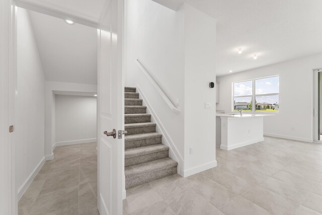 14408 SW Ellison Dr, Port Saint Lucie, FL 34987 - stairway featuring baseboards and tile patterned floors