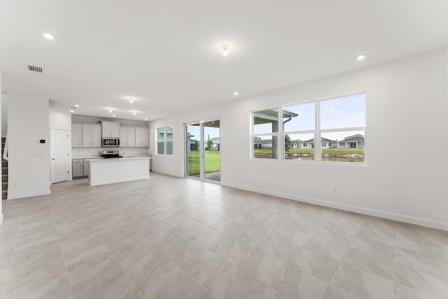 14408 SW Ellison Dr, Port Saint Lucie, FL 34987 - unfurnished living room featuring recessed lighting, baseboards, and light tile patterned floors