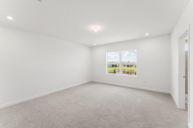 14408 SW Ellison Dr, Port Saint Lucie, FL 34987 - spare room with light carpet, recessed lighting, and baseboards