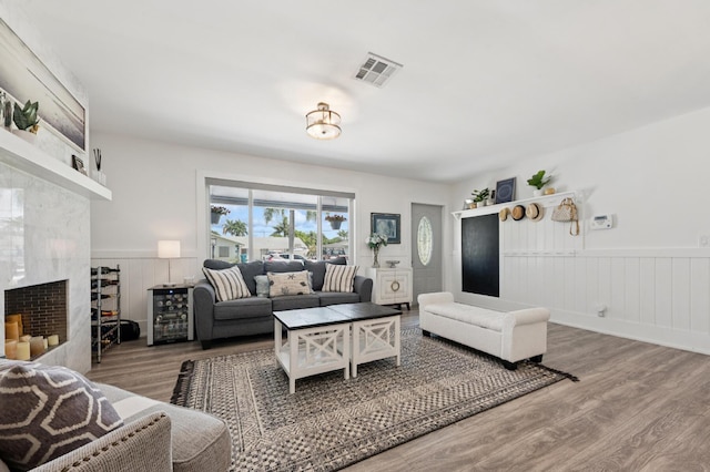 1056 SW 27th Ave, Boynton Beach, FL 33426 - living area featuring wainscoting, wood finished floors, and a premium fireplace
