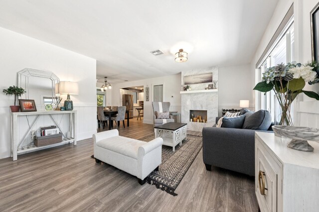 1056 SW 27th Ave, Boynton Beach, FL 33426 - living room featuring a fireplace, wood finished floors, and wainscoting