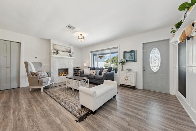 1056 SW 27th Ave, Boynton Beach, FL 33426 - living area with healthy amount of natural light, a fireplace, and wood finished floors