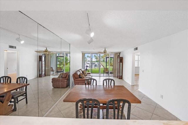1950 SW Palm City Rd Unit 5109, Stuart, FL 34994 - dining space with rail lighting, a ceiling fan, a textured ceiling, and light tile patterned floors