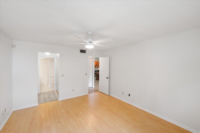 1950 SW Palm City Rd Unit 5109, Stuart, FL 34994 - unfurnished bedroom with light wood-style flooring, connected bathroom, and ceiling fan