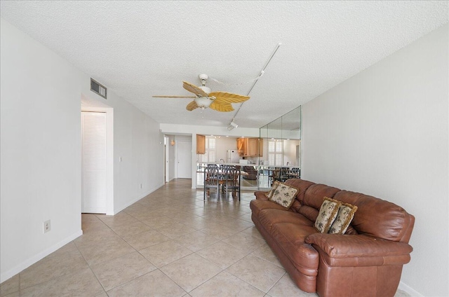 1950 SW Palm City Rd Unit 5109, Stuart, FL 34994 - living room featuring a ceiling fan, light tile patterned floors, a textured ceiling, and track lighting