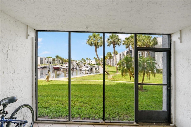 1950 SW Palm City Rd Unit 5109, Stuart, FL 34994 - doorway featuring a water view, a textured wall, plenty of natural light, a textured ceiling, and a residential view
