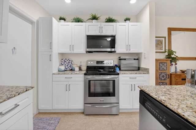 6736 Old Farm Trl, Boynton Beach, FL 33437 - kitchen with stainless steel appliances, white cabinetry, light stone counters, recessed lighting, and light tile patterned flooring