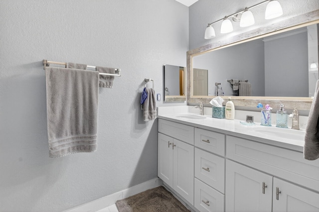 6736 Old Farm Trl, Boynton Beach, FL 33437 - bathroom featuring double vanity, a textured wall, and baseboards