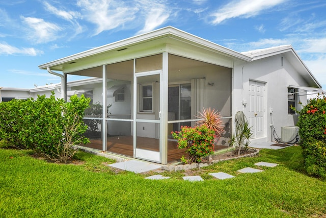 1916 SW 19th St, Boynton Beach, FL 33426 - view of home's exterior featuring a sunroom, central air condition unit, a yard, and stucco siding