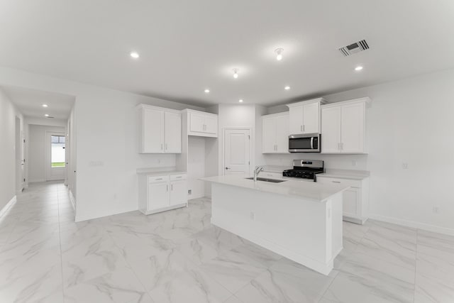 14483 SW Woodford Way, Port Saint Lucie, FL 34987 - kitchen with stainless steel appliances, light marble finish floors, baseboards, a sink, and recessed lighting