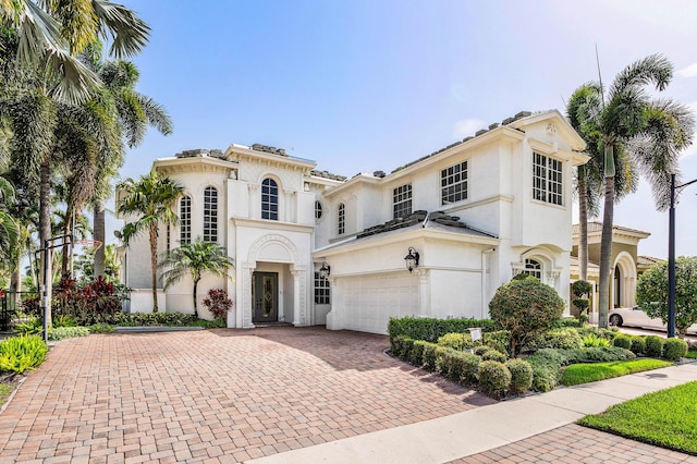 16414 Braeburn Ridge Trl, Delray Beach, FL 33446 - mediterranean / spanish house with decorative driveway, stucco siding, and an attached garage