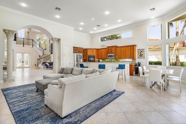 16414 Braeburn Ridge Trl, Delray Beach, FL 33446 - living area with a high ceiling, ornate columns, arched walkways, light tile patterned floors, and ornamental molding