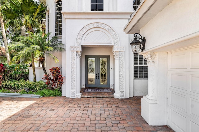 16414 Braeburn Ridge Trl, Delray Beach, FL 33446 - property entrance with french doors, stucco siding, and a garage