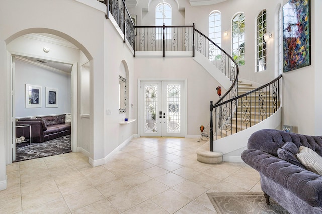 16414 Braeburn Ridge Trl, Delray Beach, FL 33446 - entrance foyer featuring french doors, ornamental molding, tile patterned flooring, stairway, and arched walkways