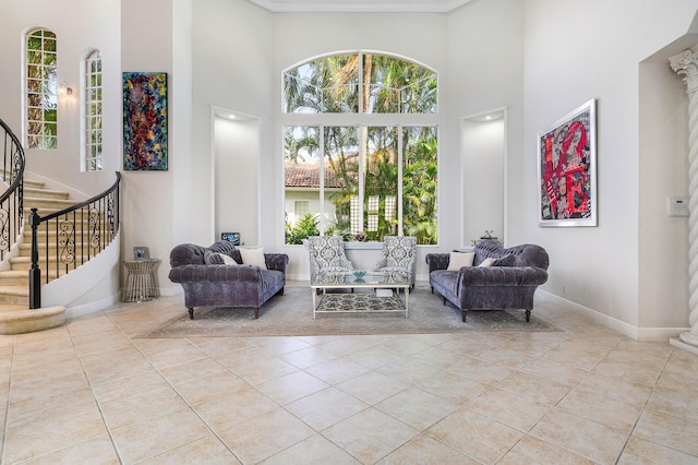 16414 Braeburn Ridge Trl, Delray Beach, FL 33446 - sitting room with a towering ceiling, stairway, tile patterned flooring, plenty of natural light, and crown molding