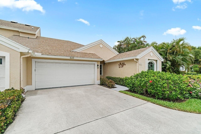 137 N Lakeshore Dr, Hypoluxo, FL 33462 - view of front of house featuring stucco siding, an attached garage, and concrete driveway