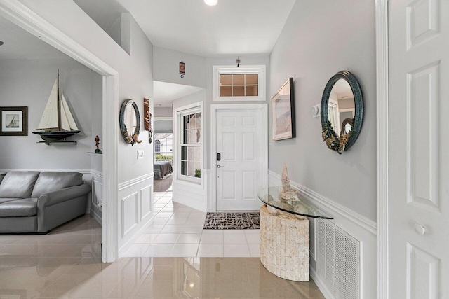 137 N Lakeshore Dr, Hypoluxo, FL 33462 - foyer entrance featuring tile patterned floors and wainscoting