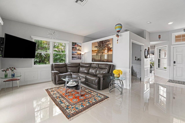 137 N Lakeshore Dr, Hypoluxo, FL 33462 - tiled living room featuring a decorative wall, a wainscoted wall, and recessed lighting