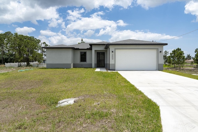 4209 25th St SW, Lehigh Acres, FL 33976 - prairie-style home with stucco siding, concrete driveway, an attached garage, and a front yard