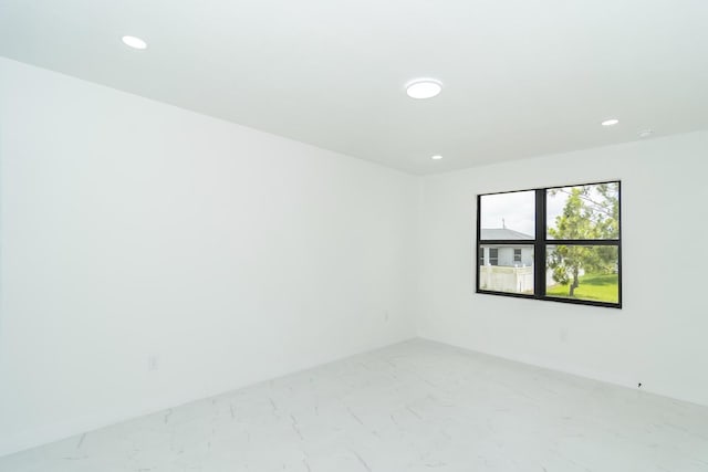 4209 25th St SW, Lehigh Acres, FL 33976 - spare room with recessed lighting, light marble finish flooring, and baseboards