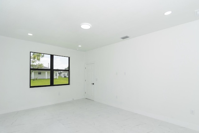 4209 25th St SW, Lehigh Acres, FL 33976 - empty room featuring light marble finish floors, recessed lighting, and baseboards