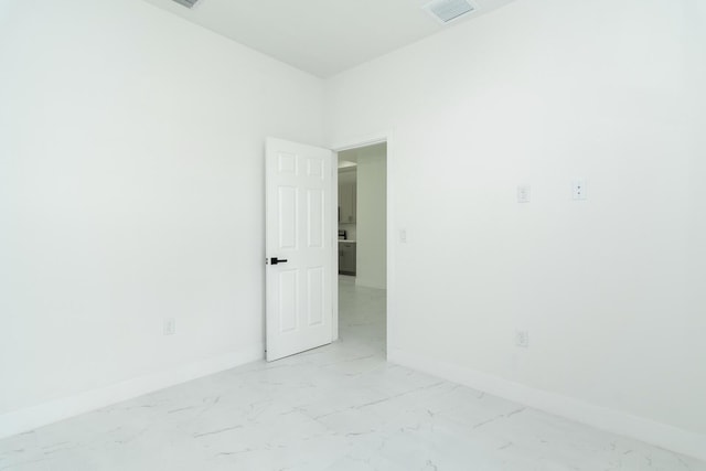 4209 25th St SW, Lehigh Acres, FL 33976 - spare room featuring light marble finish flooring and baseboards
