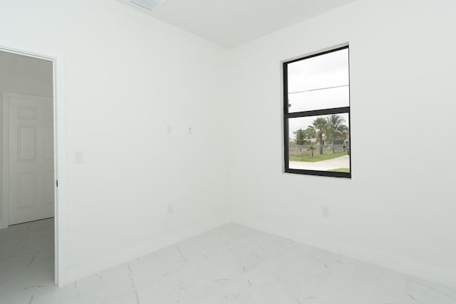 4209 25th St SW, Lehigh Acres, FL 33976 - spare room featuring light marble finish floors and baseboards