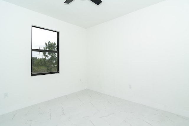 4209 25th St SW, Lehigh Acres, FL 33976 - unfurnished room with marble look tiles, baseboards, and ceiling fan