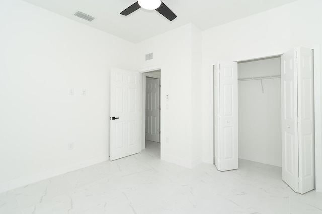 4209 25th St SW, Lehigh Acres, FL 33976 - unfurnished bedroom with marble finish floors, baseboards, ceiling fan, and a closet
