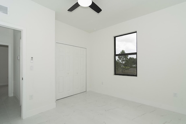 4209 25th St SW, Lehigh Acres, FL 33976 - unfurnished bedroom featuring baseboards, a closet, light marble finish floors, and ceiling fan