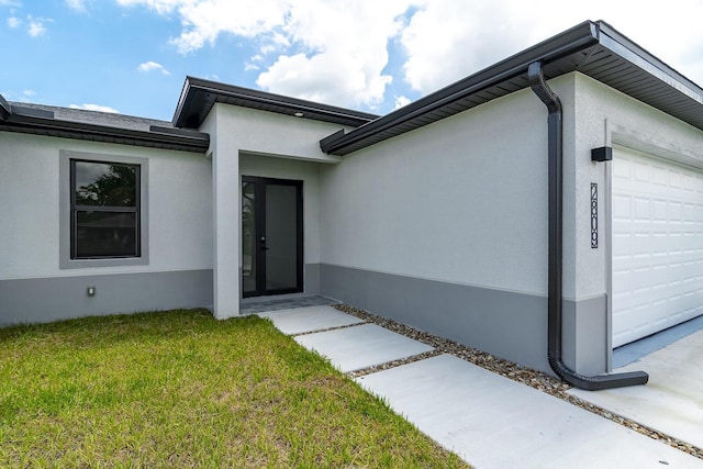 4209 25th St SW, Lehigh Acres, FL 33976 - entrance to property featuring an attached garage, stucco siding, and a yard