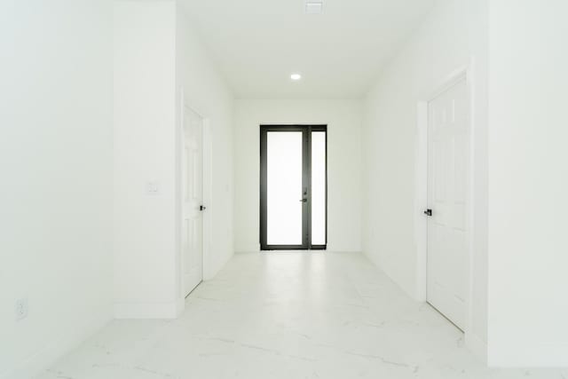 4209 25th St SW, Lehigh Acres, FL 33976 - corridor featuring light marble finish flooring, baseboards, and recessed lighting