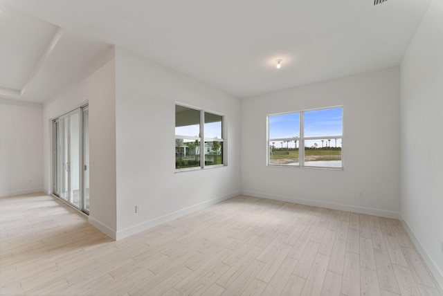 10647 SW Vineyard Dr, Port Saint Lucie, FL 34987 - spare room featuring light wood-type flooring, baseboards, and a water view