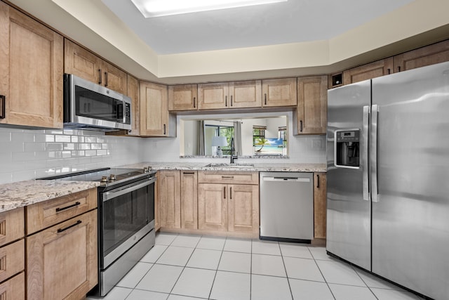 6670 Villa Sonrisa Dr Unit 224, Boca Raton, FL 33433 - kitchen with stainless steel appliances, a sink, tasteful backsplash, light tile patterned floors, and light stone counters