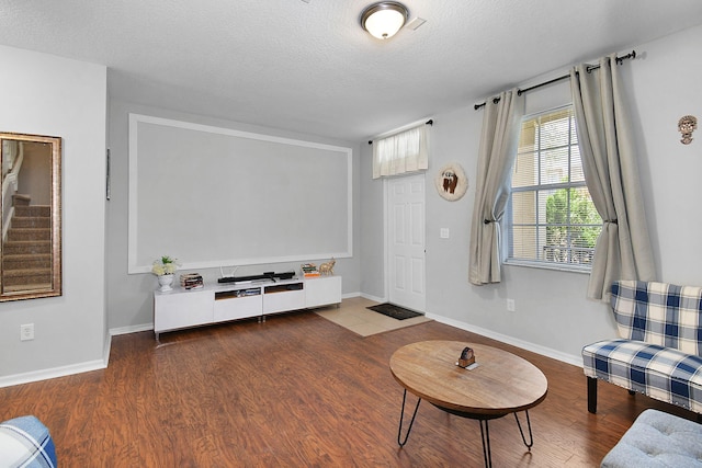 2186 SE Destin Dr, Port Saint Lucie, FL 34952 - living room with wood finished floors, a textured ceiling, baseboards, and stairway
